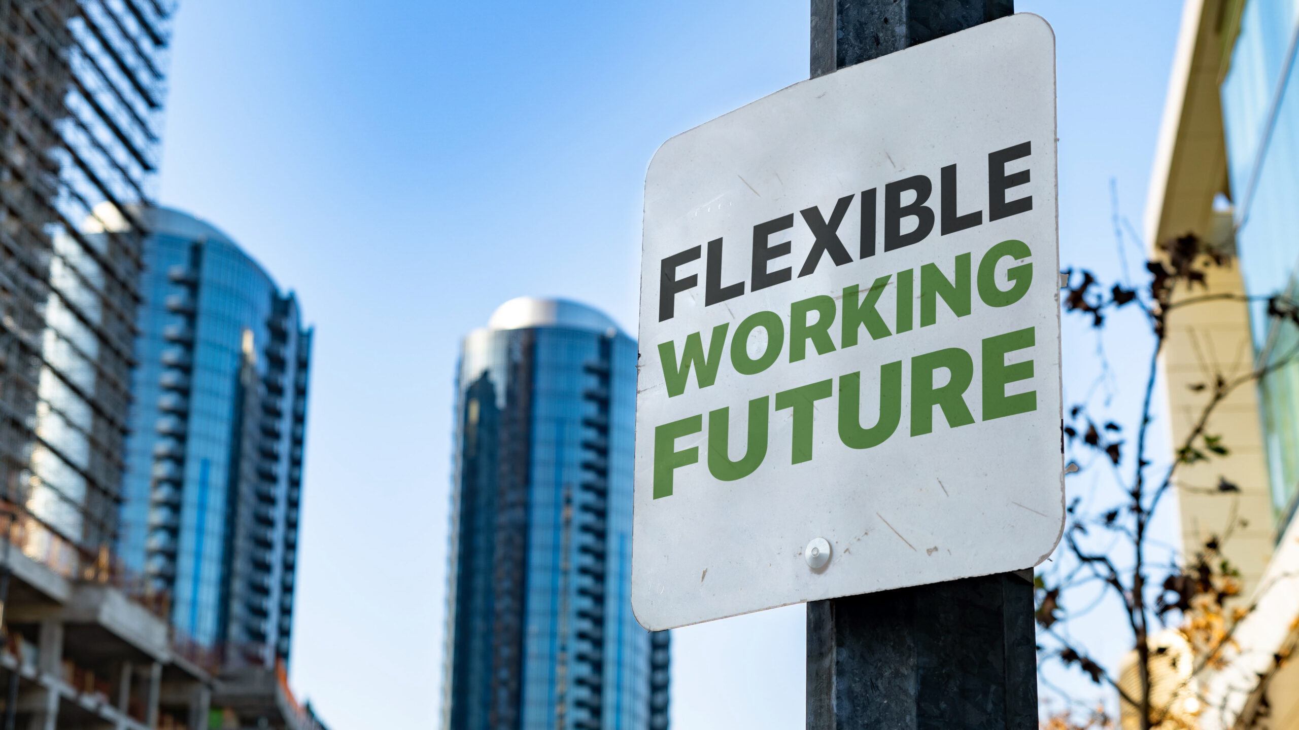 Sign reading Flexible Working Future posted against new buildings